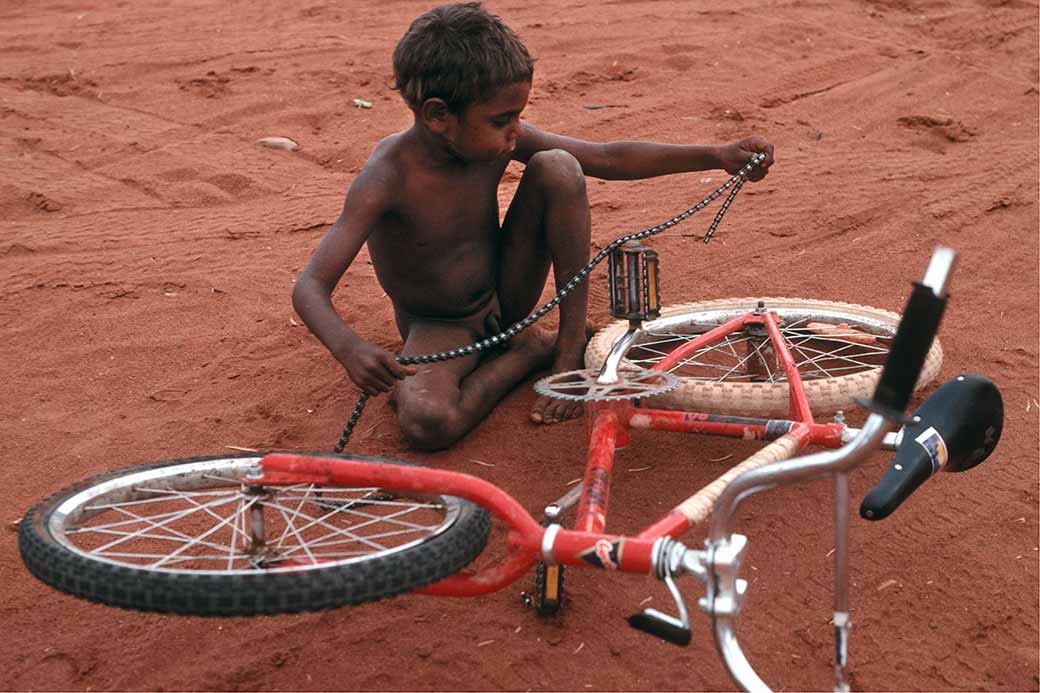 Fixing his bike