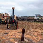 Old steam tractor and railway carriages