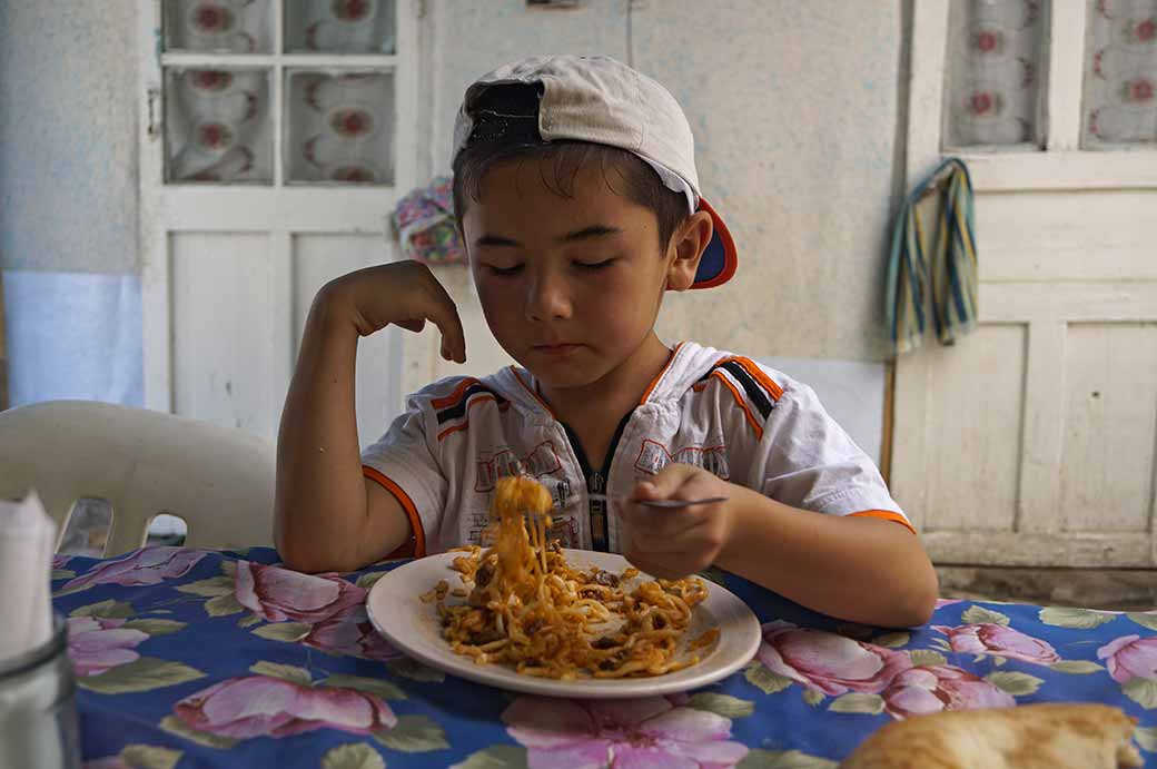 Boy eating noodles
