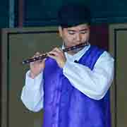Playing a bamboo flute