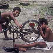 Boys fixing bicycle, Woleai
