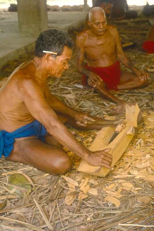 Carving the prow of a canoe