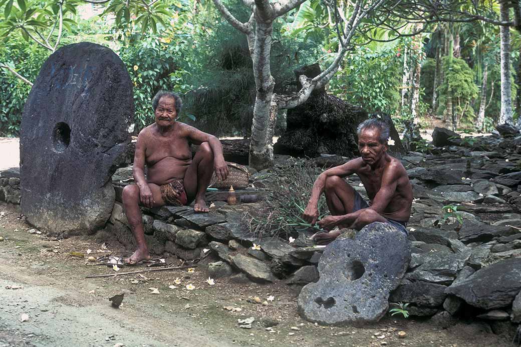 Two men and stone coins