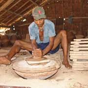 Working a pottery wheel