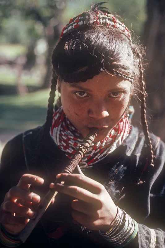 Kalash girl playing a flute
