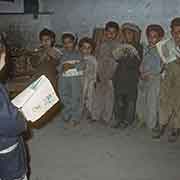 Boy reading to his classmates