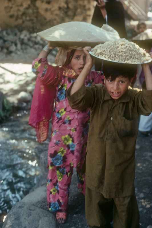 Children carrying rice