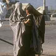Woman in burqa and child