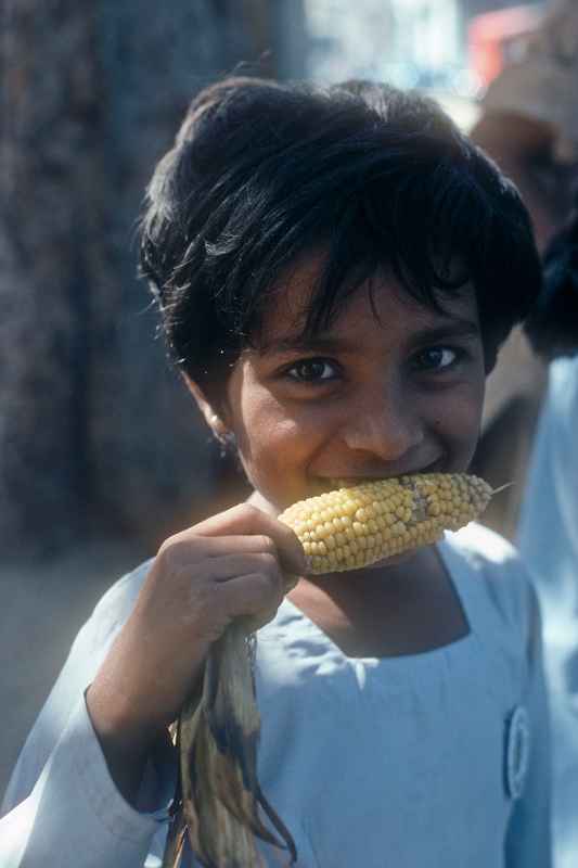 Girl, corn on the cob