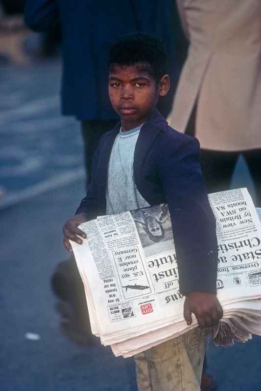 Boy selling newspapers