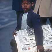 Boy selling newspapers