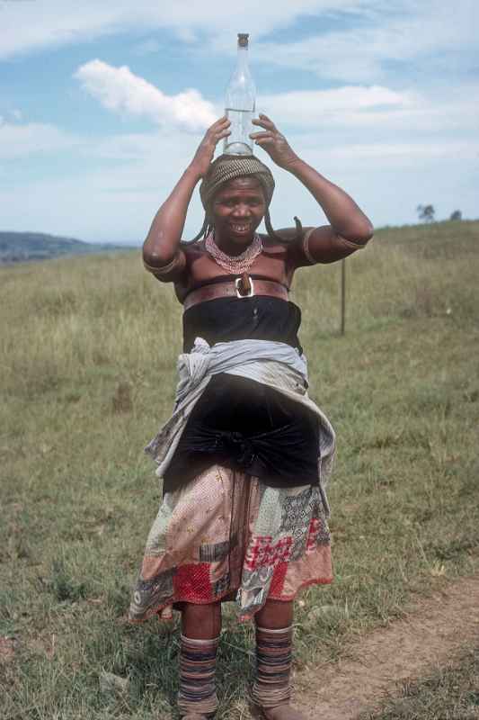 Young Mpondo woman with bottle