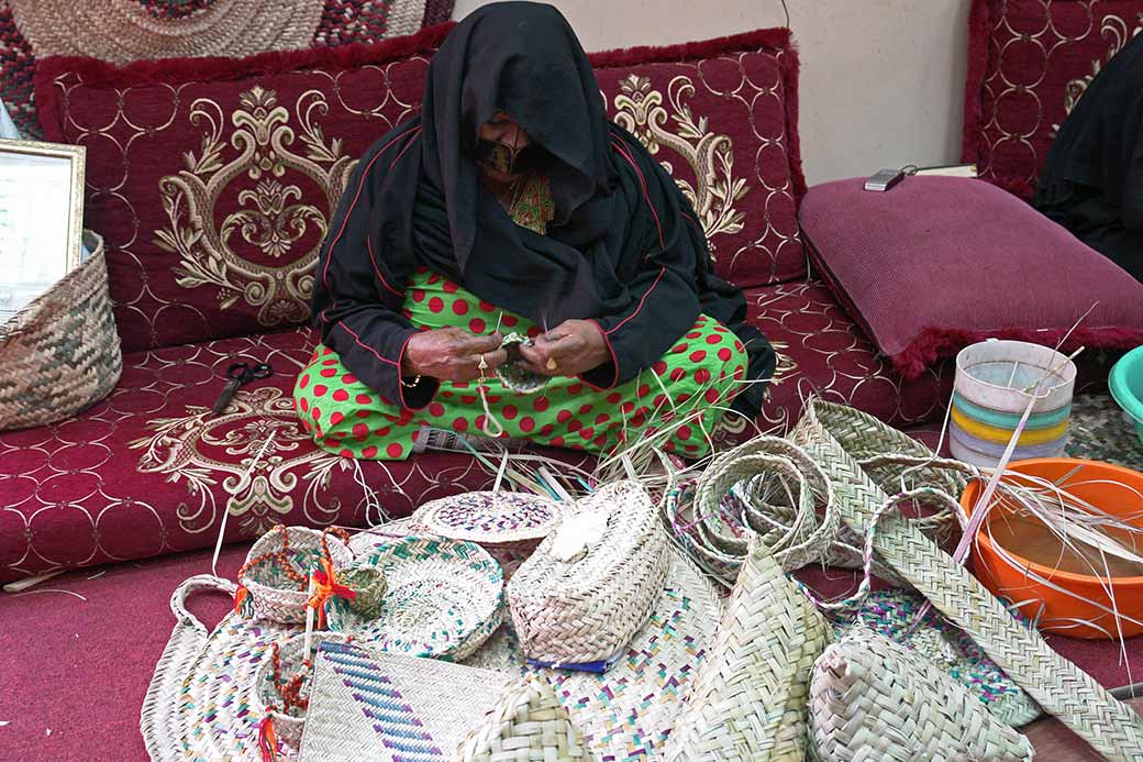 Bedou women weaving baskets